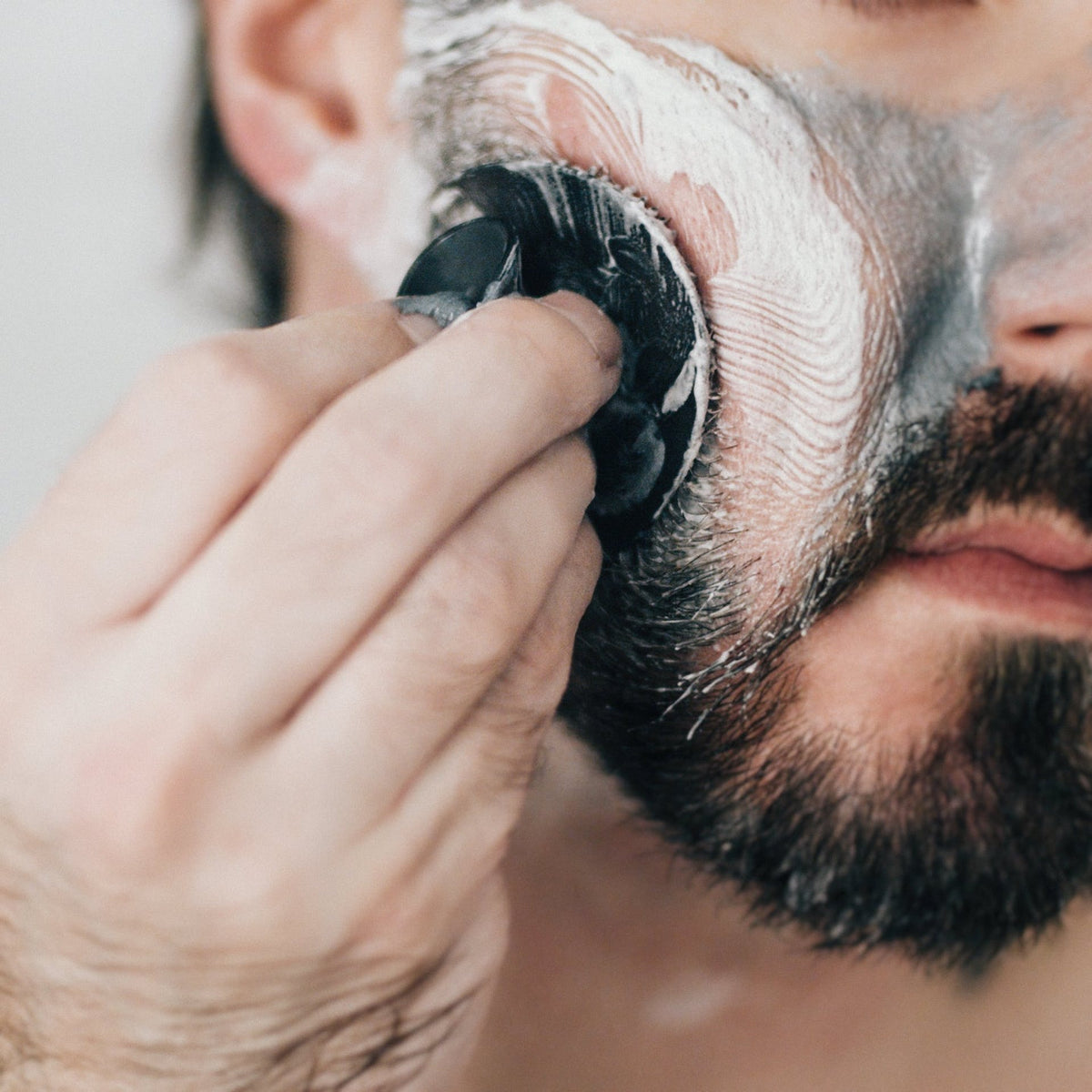 Man using the face scrubber
