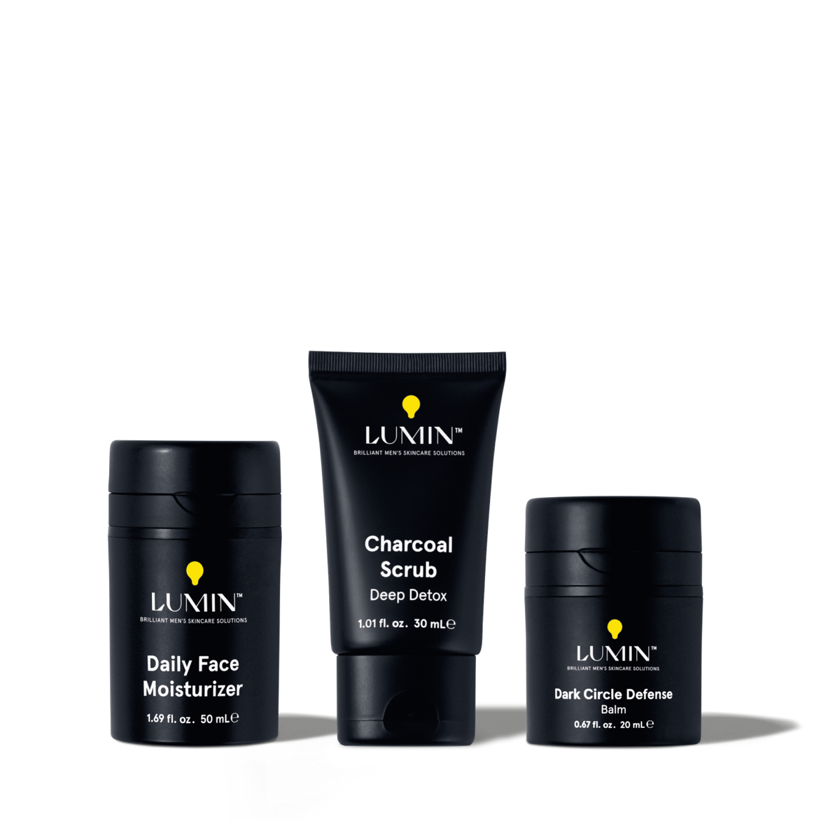 Lumin men's skincare set featuring Daily Face Moisturizer, Charcoal Scrub Deep Detox, and Dark Circle Defense Balm.