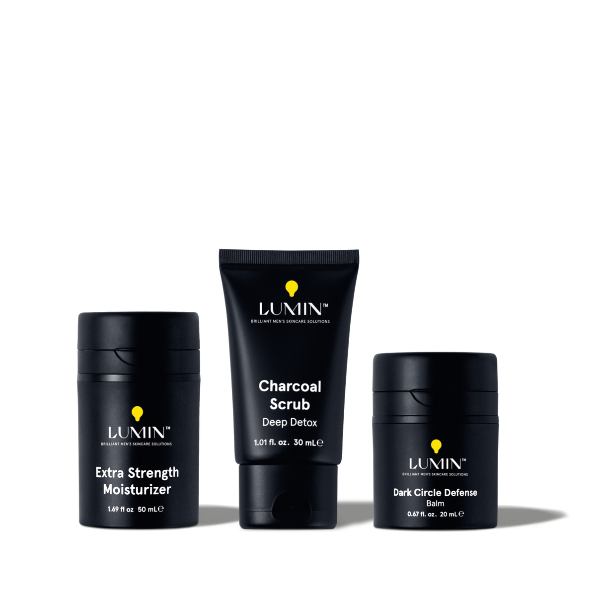 Lumin men's skincare set with Extra Strength Moisturizer, Charcoal Scrub Deep Detox, and Dark Circle Defense Balm.