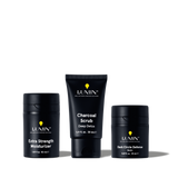 Lumin men's skincare set with Extra Strength Moisturizer, Charcoal Scrub Deep Detox, and Dark Circle Defense Balm.