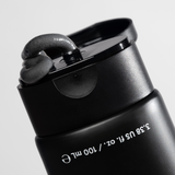 Black squeeze tube with black gel cream dispensed on flip-top cap, labeled 3.38 US fl. oz. / 100 ml skincare product.