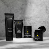 Men's skincare products set featuring Lumin charcoal face wash, charcoal scrub, anti-redness cream, and dark circle defense balm.