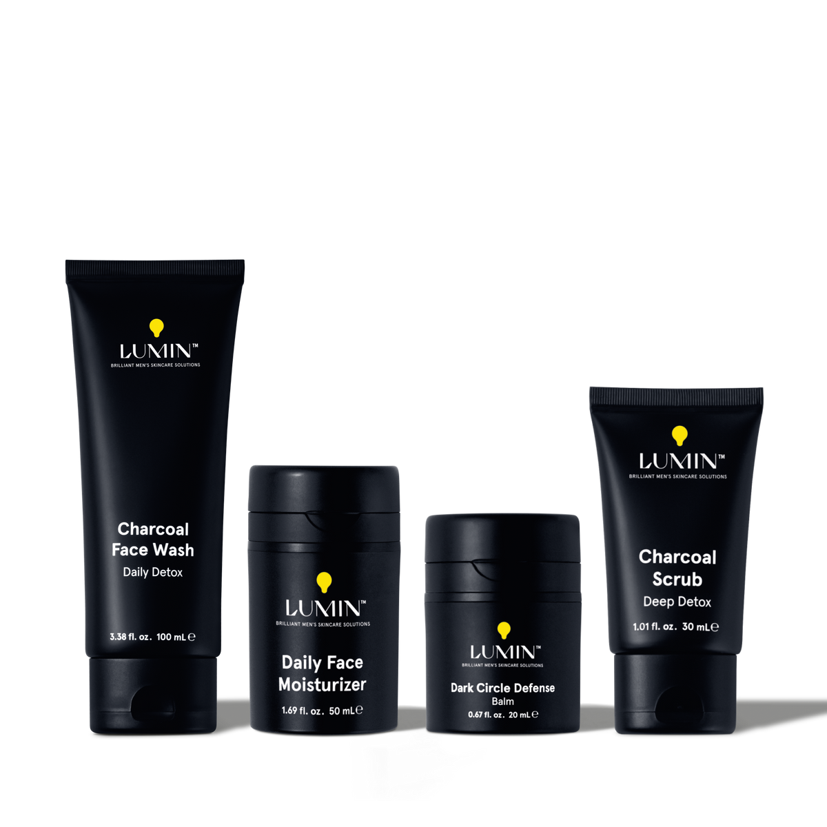 Lumin men's skincare set with Charcoal Face Wash, Daily Face Moisturizer, Dark Circle Defense Balm, and Charcoal Scrub.