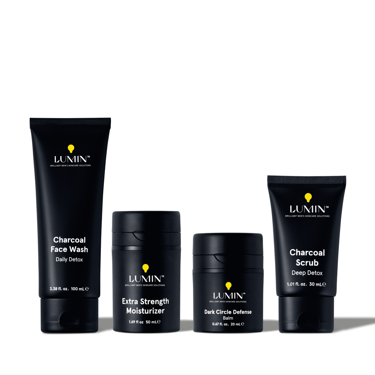 Lumin men's skincare set with Charcoal Face Wash, Extra Strength Moisturizer, Dark Circle Defense Balm, and Charcoal Scrub.