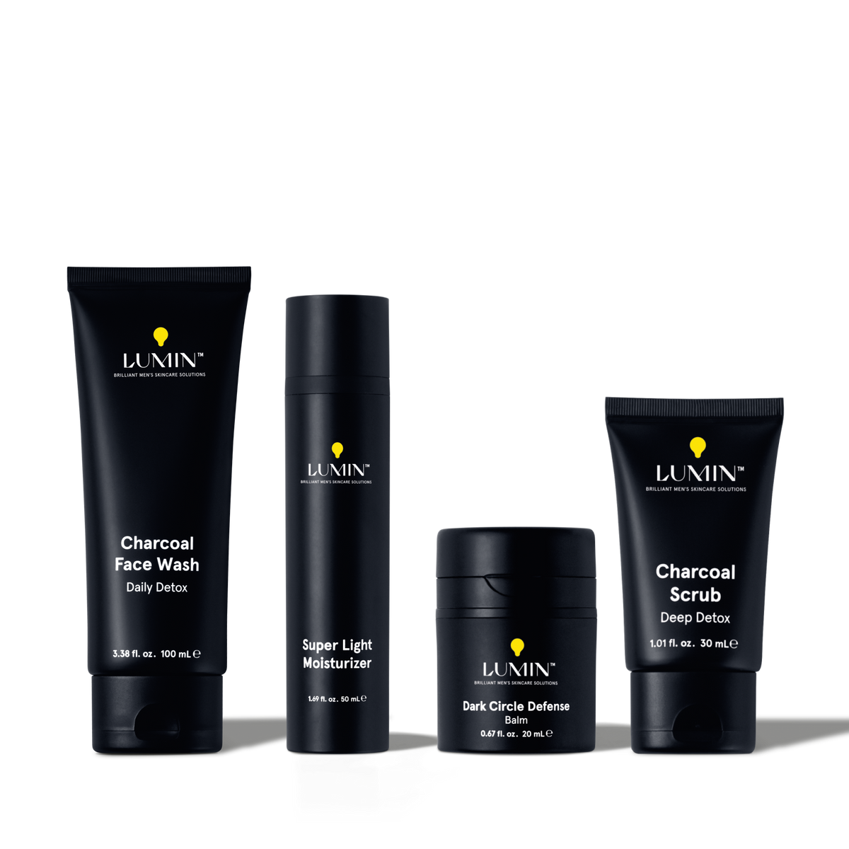 Lumin men's skincare set with Charcoal Face Wash, Super Light Moisturizer, Dark Circle Defense Balm, and Charcoal Scrub.