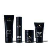 Lumin men's skincare set with Charcoal Face Wash, Super Light Moisturizer, Dark Circle Defense Balm, and Charcoal Scrub.
