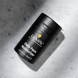 Lumin men's daily face moisturizer in black bottle on concrete background for skincare routines