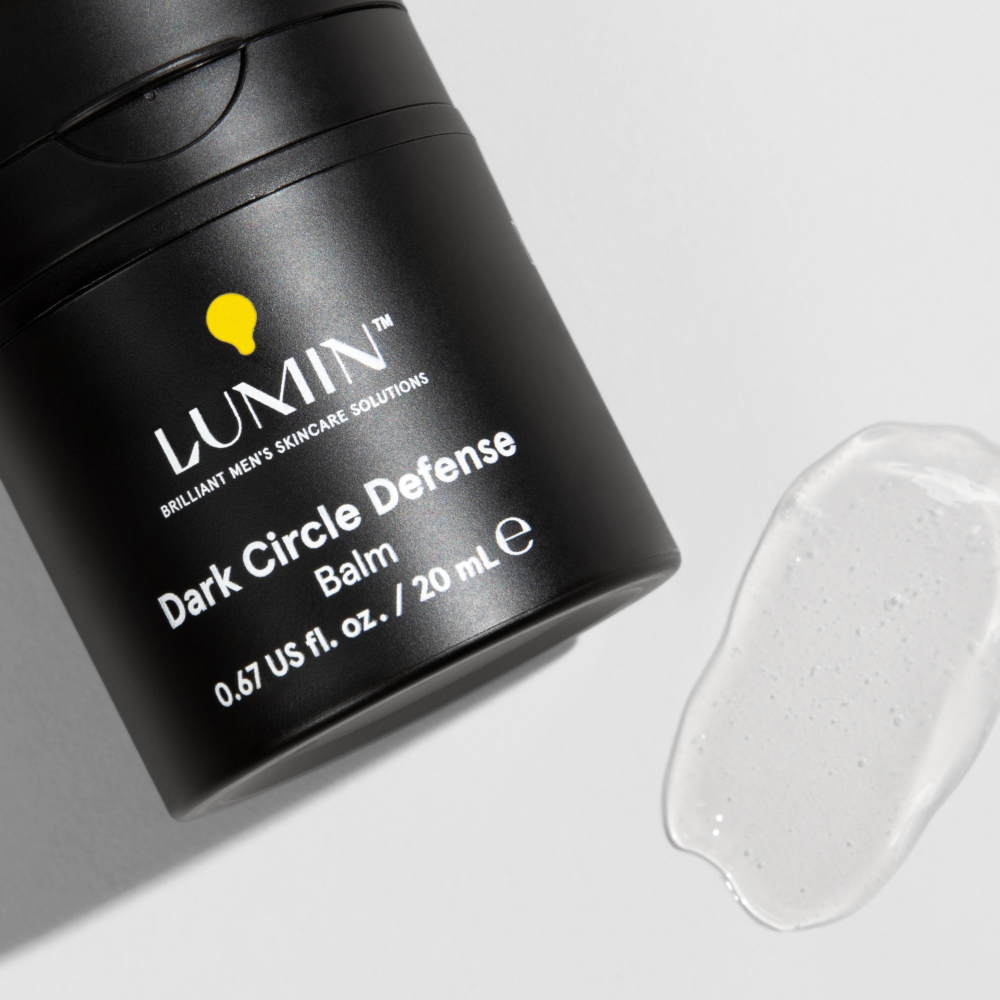 Lumin Dark Circle Defense balm container with clear gel texture on white background, men's skincare product