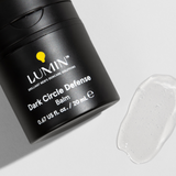 Lumin Dark Circle Defense balm container with clear gel texture on white background, men's skincare product