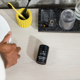 Lumin Extra Strength Moisturizer bottle on light wood bathroom counter with toothbrush holder and ring tray.