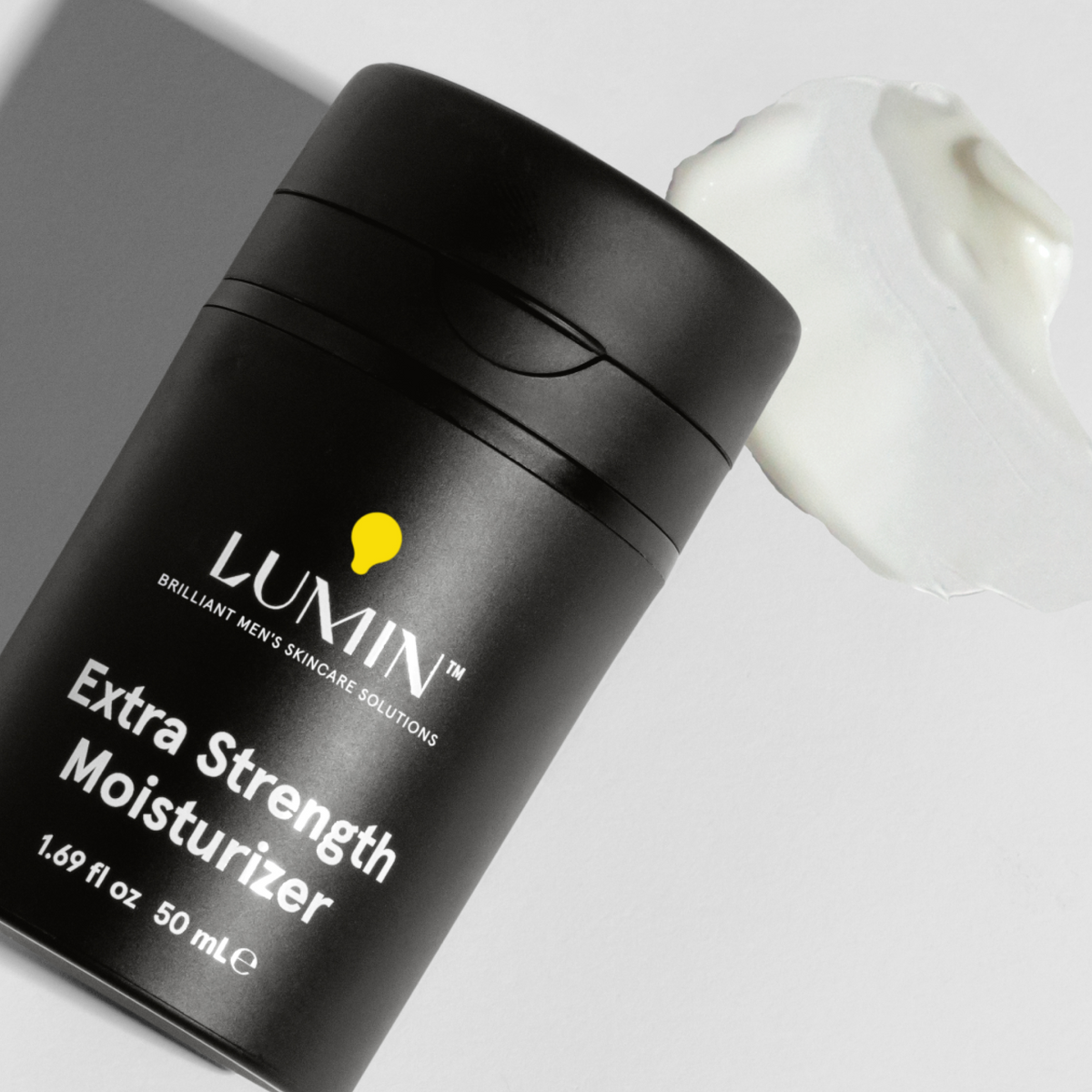 Lumin Extra Strength Moisturizer black bottle with white cream smear, men's skincare hydrating product 50ml.