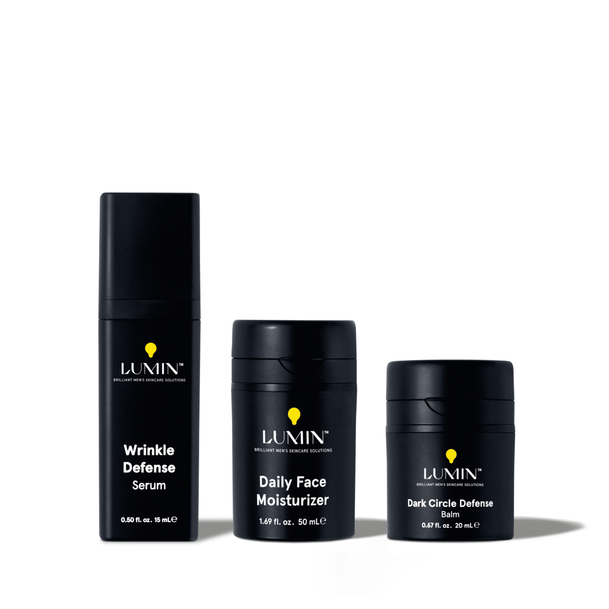 Lumin men's skincare set with Wrinkle Defense Serum, Daily Face Moisturizer, and Dark Circle Defense Balm in black packaging.