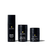 Lumin men's skincare set with Wrinkle Defense Serum, Daily Face Moisturizer, and Dark Circle Defense Balm in black packaging.