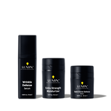 Lumin men's skincare trio: Wrinkle Defense Serum, Extra Strength Moisturizer, and Dark Circle Defense Balm in black bottles.