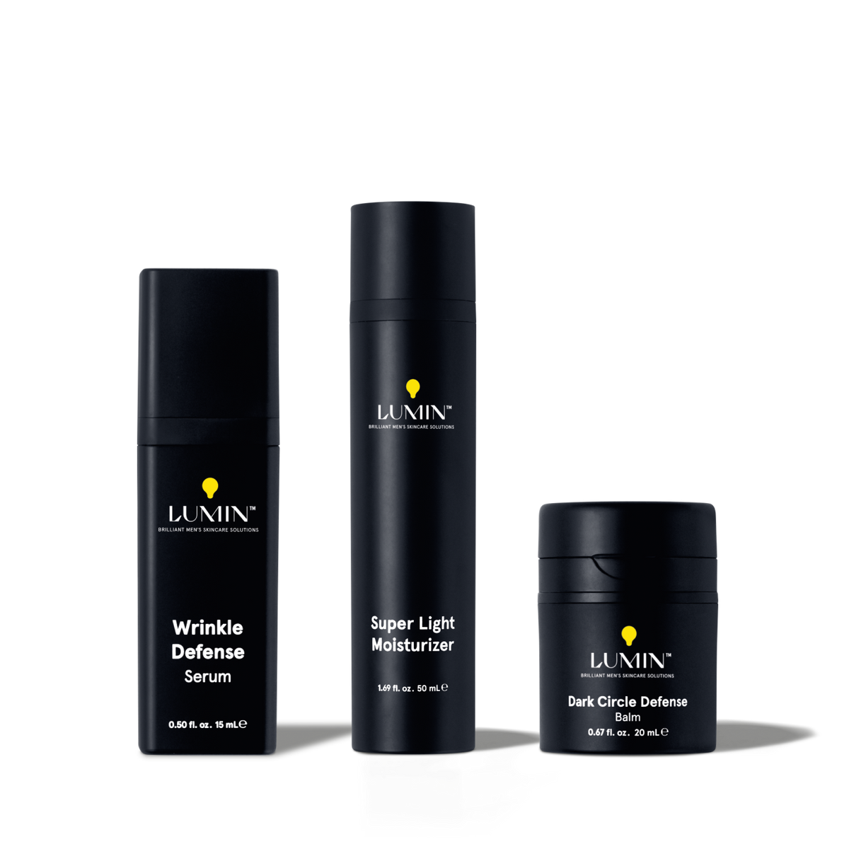 Lumin men's skincare set with Wrinkle Defense Serum, Super Light Moisturizer, and Dark Circle Defense Balm in black bottles.