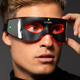 Black and red LED light therapy eye mask worn by young man for eye care and relaxation