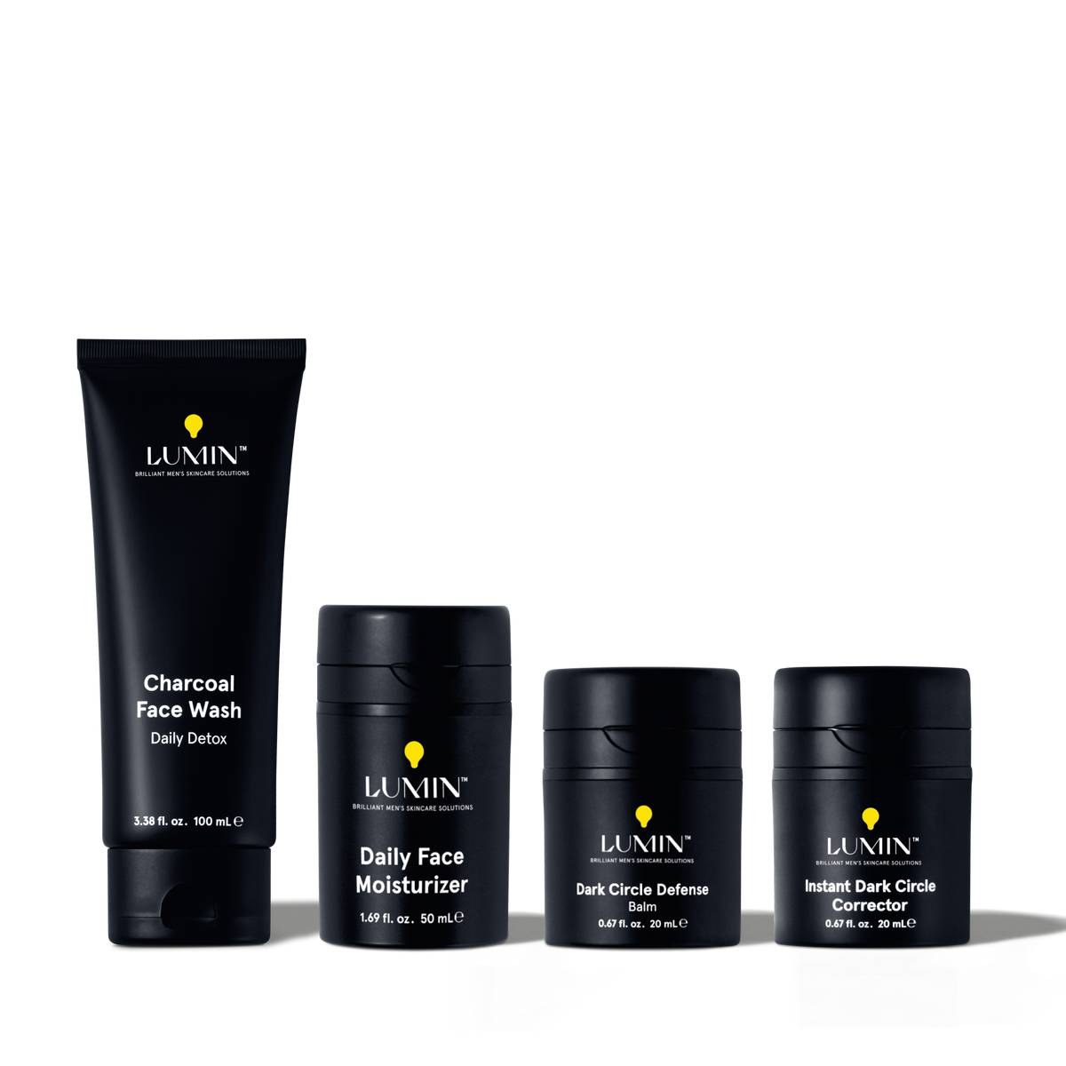 Lumin men's skincare set including charcoal face wash, daily face moisturizer, dark circle defense balm, and instant dark circle corrector.