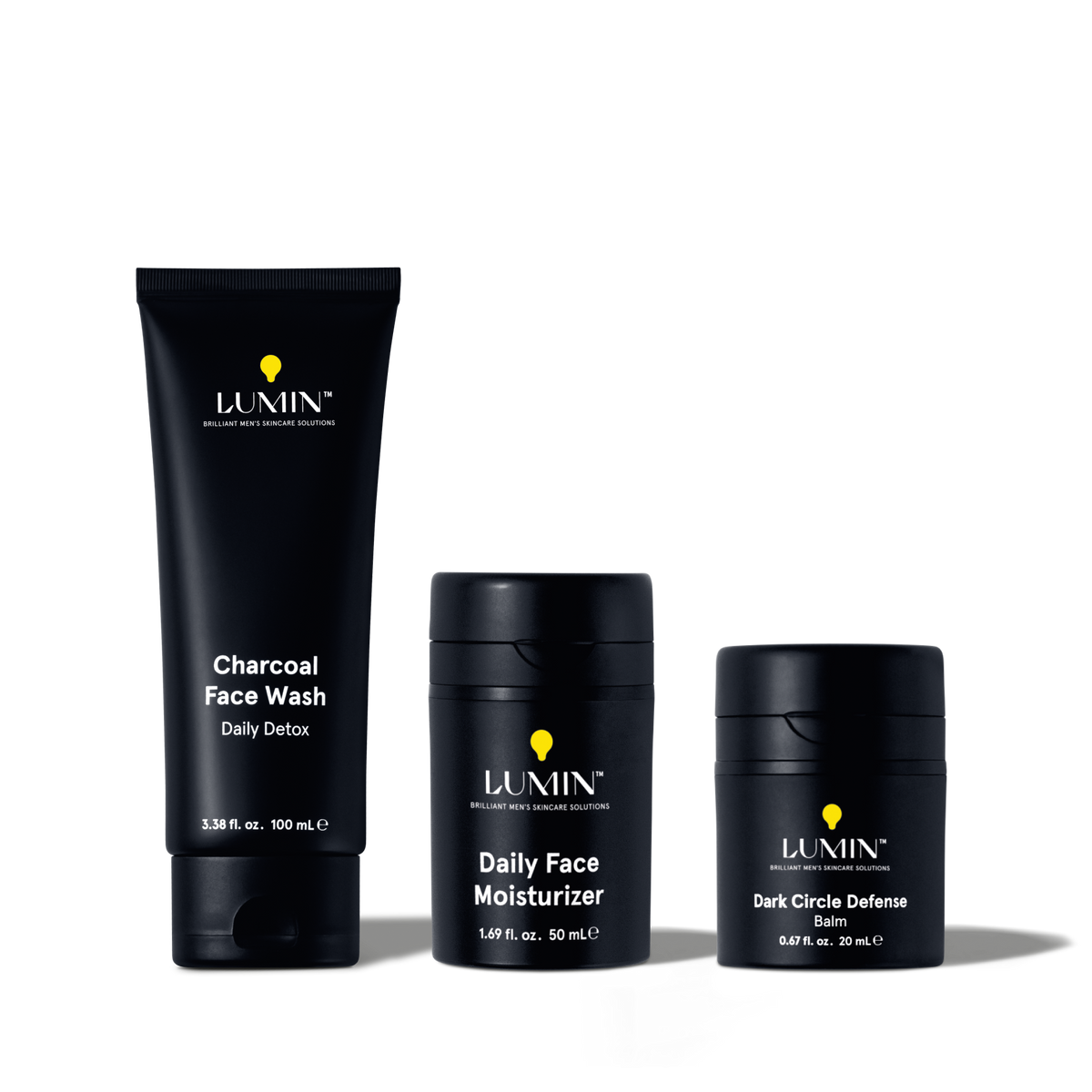 Lumin men's skincare set with Charcoal Face Wash, Daily Face Moisturizer, and Dark Circle Defense Balm in black packaging