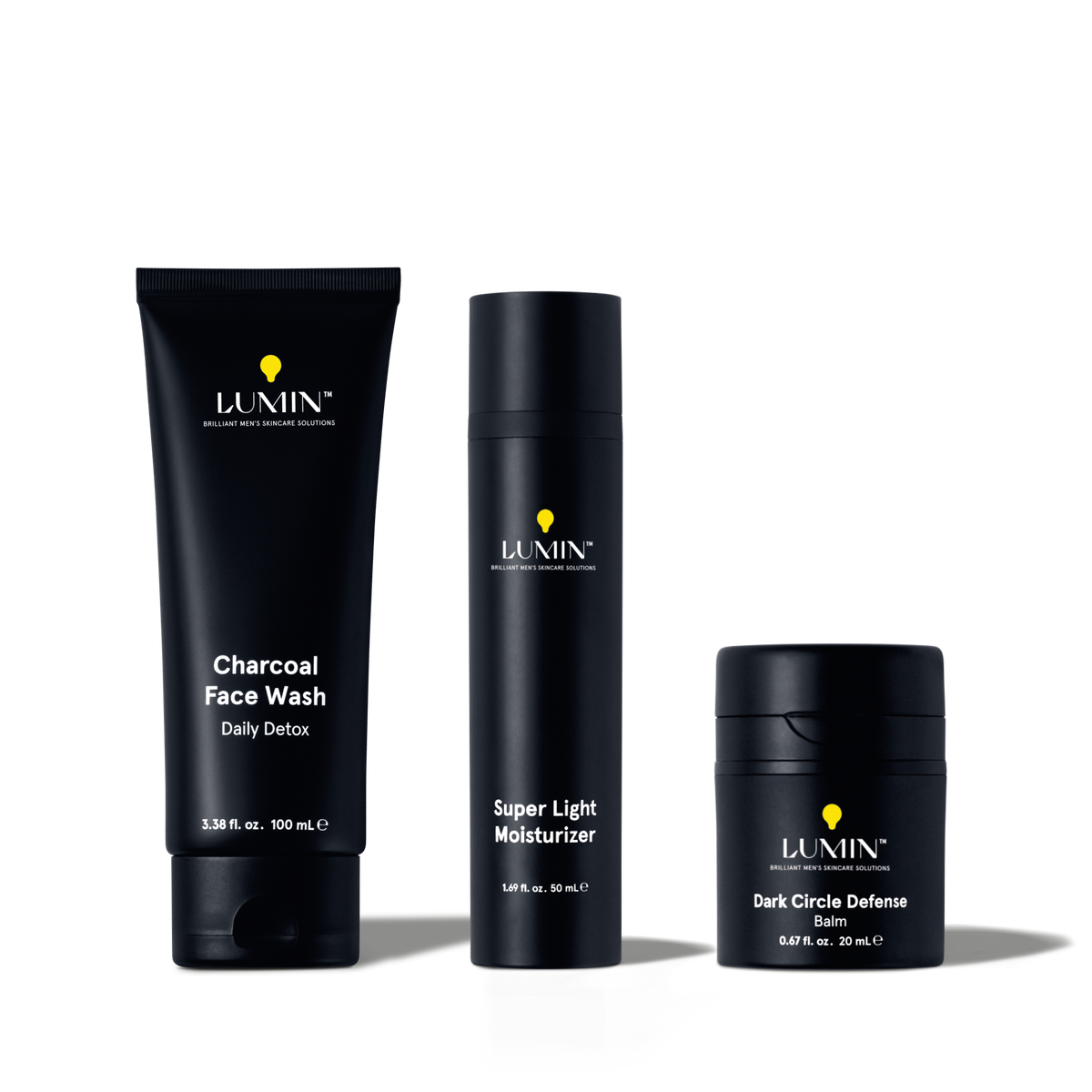 Lumin men's skincare trio with Charcoal Face Wash, Super Light Moisturizer, and Dark Circle Defense Balm in black packaging.