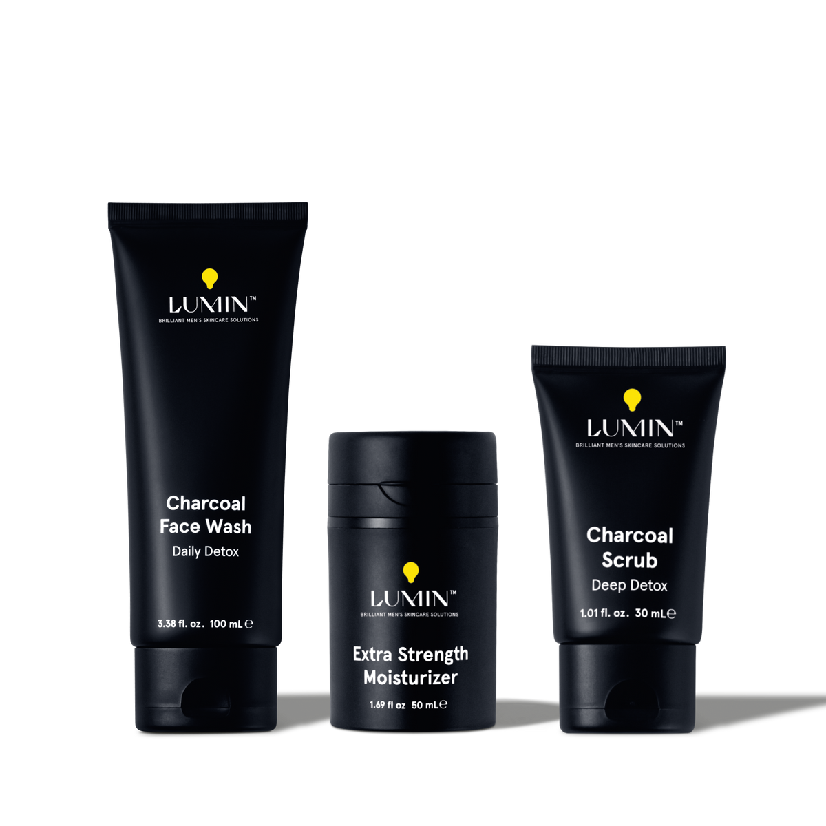 Lumin men's skincare set with Charcoal Face Wash, Extra Strength Moisturizer, and Charcoal Scrub for detox and hydration.