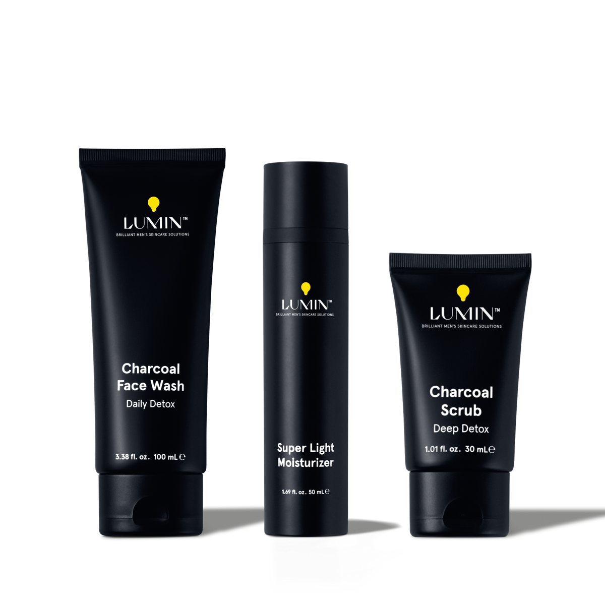 Lumin men's charcoal skincare set with face wash, super light moisturizer, and deep detox scrub in black packaging.