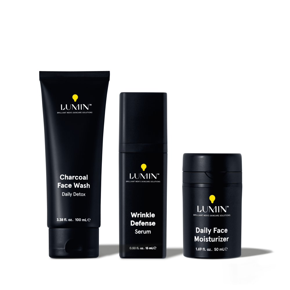 Lumin men's skincare set with Charcoal Face Wash, Wrinkle Defense Serum, and Daily Face Moisturizer in black packaging