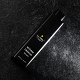 Lumin Wrinkle Defense Serum bottle on textured dark surface, men's anti-aging skincare product, 15ml packaging